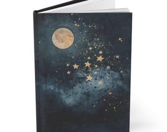 May include: A hardback journal with a celestial design. The cover features a full moon, gold stars, and a dark blue watercolor background. The journal is open, revealing white pages.