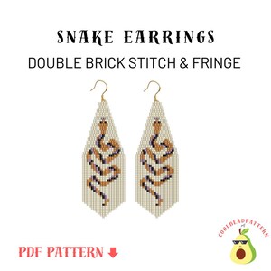 May include: A pair of beaded snake earrings with a fringe design. The earrings are made with white, brown, and purple beads. The earrings are in the shape of a snake with its head facing upwards. The earrings are hanging from gold hooks. The text "SNAKE EARRINGS DOUBLE BRICK STITCH & FRINGE" is at the top of the image. The text "PDF PATTERN" is at the bottom of the image. The image also includes a logo with an avocado wearing sunglasses.