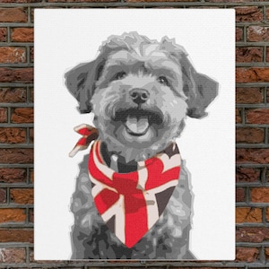 May include: A black and white photograph of a small dog wearing a red, white and blue bandana with a Union Jack pattern. The dog is smiling and has a happy expression.
