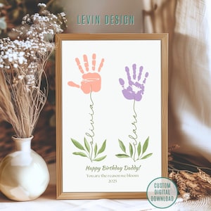 May include: A framed print featuring two handprints in peach and purple, with the names "Olivia" and "Clare" written below. The text "Happy Birthday Daddy!" and "You are the reason we bloom 2025" is also included. The print is a custom digital download.