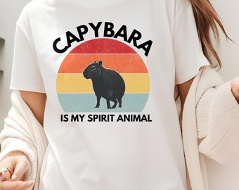 May include: White t-shirt with a retro-style graphic of a capybara and the text "Capybara is my spirit animal."