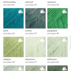 May include: A collection of yarn samples in various colors, including light blue, teal, green, and gray. Each sample is labeled with a color name and number. The yarn appears soft and fluffy.