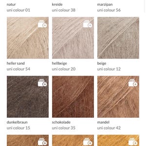 May include: A collection of yarn samples in various colors, including white, beige, brown, and yellow. Each sample is labeled with a color name and a unique identifier. The yarn appears soft and fluffy, suitable for knitting or crochet projects.