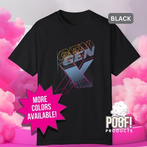 May include: Black t-shirt with a colorful graphic design featuring the text "GEN X" in a 3D style. The design includes a grid and a large "X". The shirt also has a tag that says "BLACK". A pink starburst graphic says "MORE COLORS AVAILABLE!"
