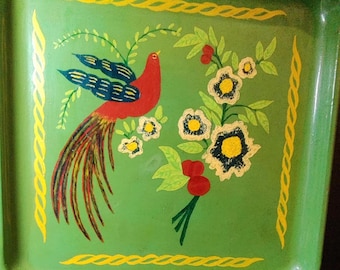 May include: Green metal tray with a decorative bird and floral design. The bird is red with blue and yellow accents, and the flowers are white with yellow centers. A yellow border frames the design.
