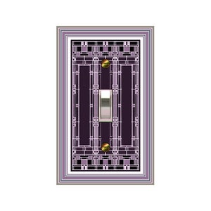 May include: A light switch cover with a geometric design in shades of purple, black, and white. The switch cover has a silver toggle switch.