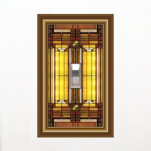 May include: A light switch cover with a stained glass design featuring geometric shapes in shades of brown, yellow, and red. The switch is in the center of the design.