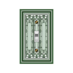 May include: A green light switch plate with a geometric design in shades of green and white. The switch plate has a single toggle switch.