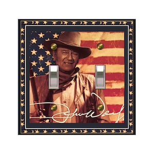May include: A double light switch cover featuring a vintage image of John Wayne in front of an American flag. The image is in sepia tones and includes Wayne's signature.