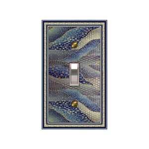May include: A light switch cover with a blue and gold Japanese-inspired pattern. The cover has a decorative border and a silver switch plate.