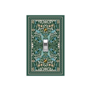 May include: A decorative light switch cover with a detailed floral pattern in shades of green, blue, and cream. The design features stylized flowers and leaves, framed by a dark green border. The switch itself is silver.