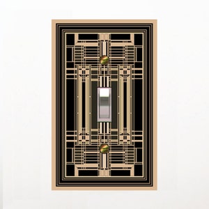 May include: Art Deco style light switch cover with a geometric design in black, gold, and beige. The cover features a toggle switch and two gold-colored decorative accents.