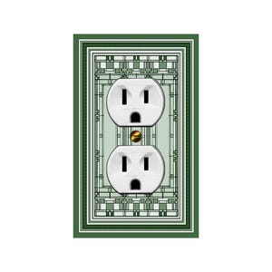 May include: A green and white patterned wall plate with two standard electrical outlets. The outlets are white and have a gold-colored ground wire.
