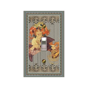 May include: A light switch cover with a decorative design featuring a woman with a floral crown and a flowing gown. The design is framed in a gold and green ornate frame.