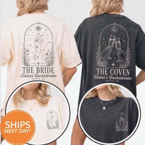 May include: A cream t-shirt and a charcoal gray t-shirt featuring black line art designs. The cream shirt displays a hand, stars, and the text THE BRIDE Elaine's Bachelorette BOSTON, MA. The gray shirt shows two hands holding champagne flutes and the text THE COVEN Elaine's Bachelorette BOSTON, MA. Both shirts include smaller matching chest prints.