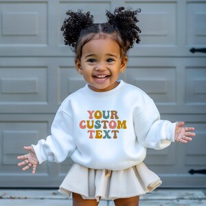 a little girl standing in front of a garage door