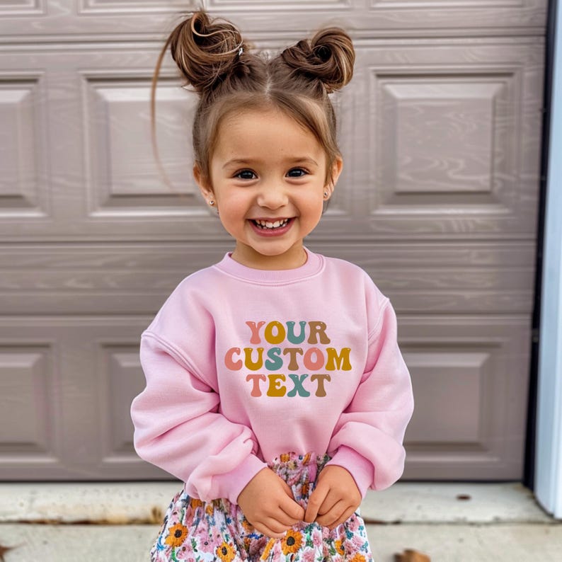 a little girl standing in front of a garage door