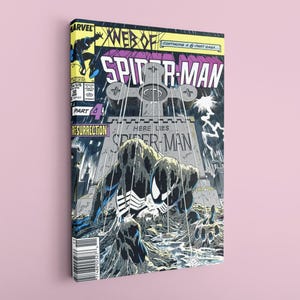 May include: A canvas print of a Spider-Man comic book cover. The artwork shows Spider-Man in a graveyard with the text "Here Lies Spider-Man." The colour scheme includes black, white, and grey tones.