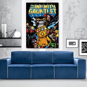May include: A large framed comic book art print of "The Infinity Gauntlet" featuring Thanos and various Marvel characters. The artwork is vibrant with a gold gauntlet, purple Thanos, and a blue and yellow background. The print hangs above a blue sofa.
