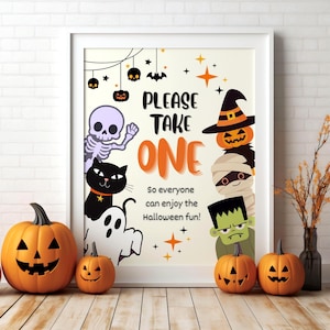 May include: A framed Halloween-themed sign with the text "PLEASE TAKE ONE" and various cartoon characters, including a skeleton, black cat, ghost, and pumpkins. Orange and black accents are used throughout the design.
