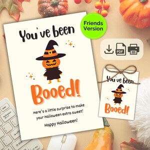 May include: A Halloween-themed printable card and tag set. The card features a pumpkin character in a witch hat with the text "You've been Booed!" and "Happy Halloween!". A smaller tag with the same design is also included.
