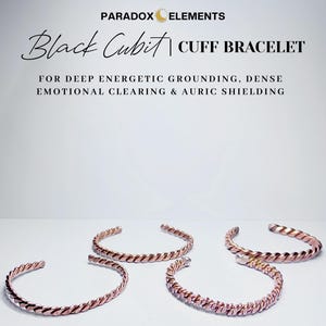May include: Four copper-coloured cuff bracelets with a twisted rope design are displayed on a white surface. The bracelets are open-ended and have a metallic sheen. The text "Black Cubit Cuff Bracelet" is visible.