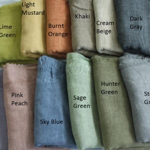 May include: A collection of 12 fabric swatches in various colours, including lime green, light mustard, burnt orange, khaki, cream beige, dark grey, pink peach, lilac, sage green, sky blue, hunter green, and stone grey.