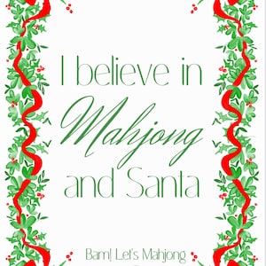 May include: A white rectangular card with a festive Christmas border. The border features green holly leaves, red berries, and red ribbons. The text in the centre reads "I believe in Mahjong and Santa" in green script. At the bottom, it says "Bam! Let's Mahjong".