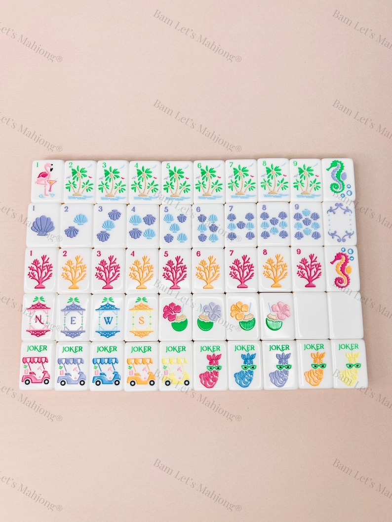May include: A set of white Mahjong tiles with colorful illustrations. The tiles feature images of palm trees, seashells, coral, and seahorses. Some tiles have the word "JOKER" and images of golf carts and llamas.