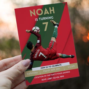 May include: Red and green soccer-themed birthday invitation for a boy turning seven. The invitation features a photo of a soccer player in a red and green uniform with the number seven on the back. The text on the invitation reads "Noah is turning 7" and includes details about the party, including the date, time, and RSVP information.