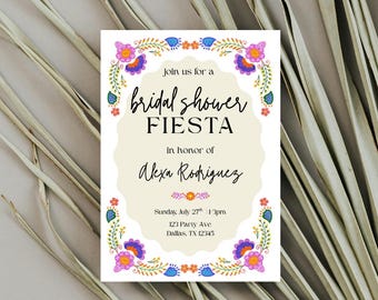 May include: A bridal shower invitation with a floral border in purple, orange, and blue. The invitation reads "Join us for a bridal shower Fiesta in honor of Alexa Rodriguez." The date and time are listed as Sunday, July 27th at 1:30 pm.
