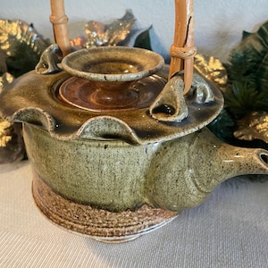 Vintage Asian style stoneware teapot with bamboo handle. artist signed