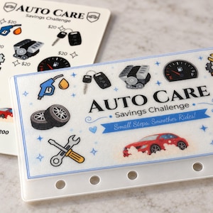 May include: Two rectangular white plastic savings challenge cards featuring the text AUTO CARE Savings Challenge. The cards display colorful illustrations of car parts, including tires, a fuel pump, a car engine, a wrench, and a red car.