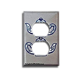 May include: A white ceramic outlet cover with a blue and white teapot design. The outlet cover has two standard outlets.