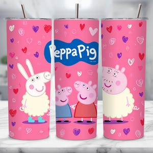 May include: A pink tumbler featuring Peppa Pig characters and heart doodles. The tumbler has a silver straw and a lid. The design includes Peppa Pig, her family, and a sheep character. The tumbler is designed for cold beverages.