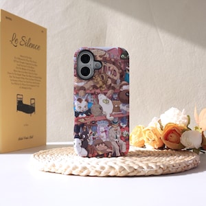 May include: A patterned phone case with a cartoon illustration of cats in a detailed, cartoon style. The case has a glossy finish and a camera cutout. A book titled "Le Silence" is visible in the background.