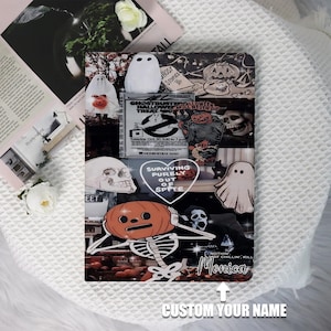 Peut inclure: Un design de style collage avec un crâne noir et blanc, un squelette tenant une citrouille, un fantôme et un cœur avec le texte "Survivre purement par dépit". Le design comprend également le texte "Ghostbusters Halloween Treat Now" et "Nothing just chillin, kill Monica".