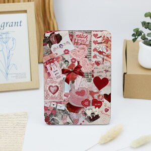 May include: A collage of red and pink hearts, flowers, and other Valentine's Day themed imagery. The collage is on a white background and includes the text "match made in heaven", "I love you", and "My Valentine".