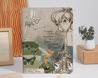May include: A rectangular notebook featuring Tinker Bell illustrations, green butterflies, and a sketch of Big Ben. The cover includes the text: Laughter is timeless, imagination has no age, dreams are forever, and All you need is faith, trust and a little bit of.