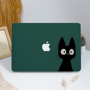 May include: A dark green laptop case featuring a white Apple logo and a black cat illustration with large, round eyes. The cat's silhouette is on the right side of the case, adding a playful touch to the design.