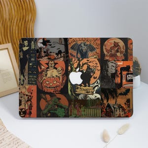 May include: A laptop skin featuring a collage of Halloween-themed illustrations, including a vampire, werewolf, witch, black cat, jack-o'-lanterns, and a haunted house. The design incorporates the text "HALLOWEEN" and "BEWARE!" in a dark, orange, and black color palette, with a central cutout for an Apple logo.