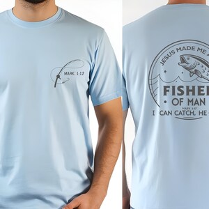 a man wearing a light blue shirt with a fish on it