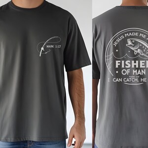 a man wearing a t - shirt with a fish on it