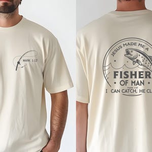 a man wearing a t - shirt with a fish on it