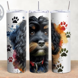 May include: Three stainless steel tumblers with a watercolor design featuring a black and brown dog with paw prints. The tumblers are white with a clear lid and a straw.