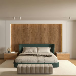 May include: A modern bedroom featuring a bed with a dark green headboard, light-colored bedding, and a matching bench at the foot. The bed is set against a wooden panel wall with warm lighting. Two wooden nightstands flank the bed.