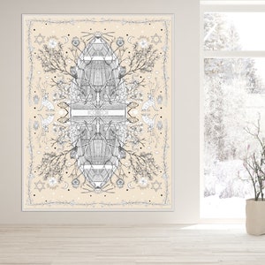 May include: A large, rectangular wall art piece with a cream-colored background. The artwork features a symmetrical black and white illustration of botanical elements, geometric shapes, and celestial motifs. The piece is framed in white and hangs on a white wall.