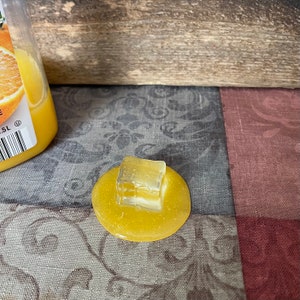 Fake Ice Cube in Orange Juice Puddle Photo Staging Prop