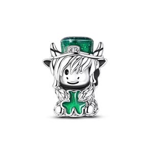 May include: A silver charm featuring a cartoon-style figure with a green top hat and a green shamrock. The figure has white hair and is holding a green shamrock. The charm is likely for a bracelet or necklace.