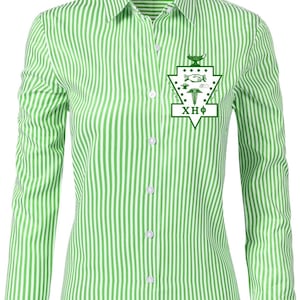 May include: A green and white striped button-down shirt with long sleeves. The shirt features a green emblem with the Greek letters XHΦ on the chest. The shirt has a classic collar and buttoned cuffs.